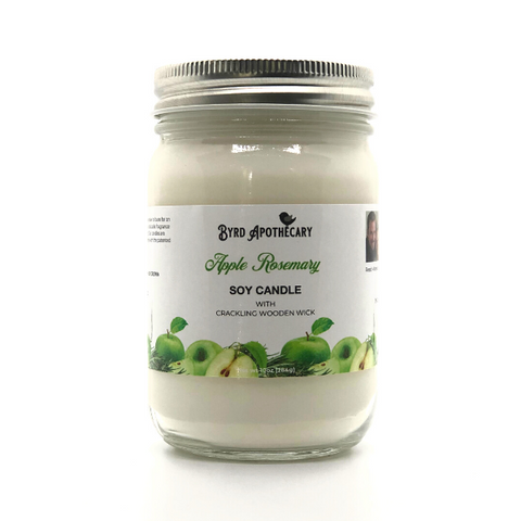 Photo of Byrd Apothecary Apple Rosemary Soy Candle with crackling Wooden Wick in a canning jar. The label background is green apples and fresh rosemary.