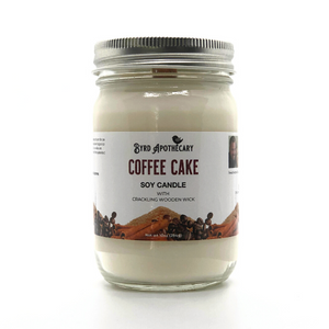 Photo of Byrd Apothecary Coffee Cake Soy Candle with crackling Wooden Wick in a canning jar. The label background is whole coffee beans, a mound of brown sugar and cinnamon sticks.