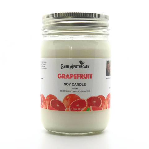 Photo of Byrd Apothecary Grapefruit Soy Candle with crackling Wooden Wick in a canning jar. The label background is whole and cut open grapefruits.