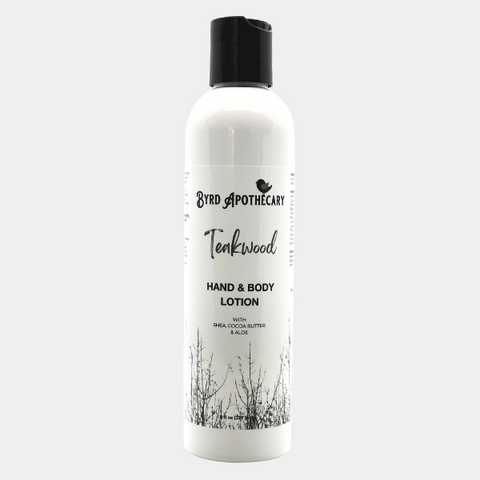 Photo of Byrd Apothecary Teakwood Hand & Body Lotion - with Shea, Cocoa Butter & Aloe. The label background is a black and white photo of leafless trees.