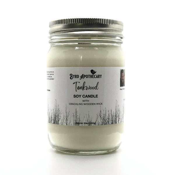 Photo of Byrd Apothecary Teakwood Soy Candle with crackling Wooden Wick in a canning jar. The label background is a black and white photo of leafless trees.