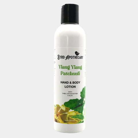 Photo of Byrd Apothecary Ylang Ylang Patchouli Hand & Body Lotion - with Shea, Cocoa Butter & Aloe. The label background is yellow ylang ylang flowers and patchouli leaves.